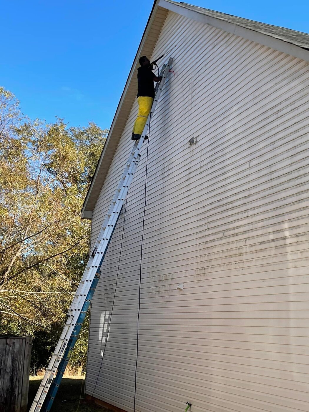 Pressure washing exterior siding before painting