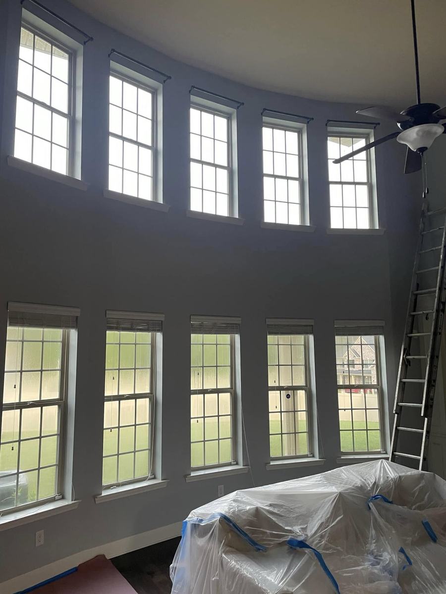 Two-story interior repaint with tall accent walls and window trim