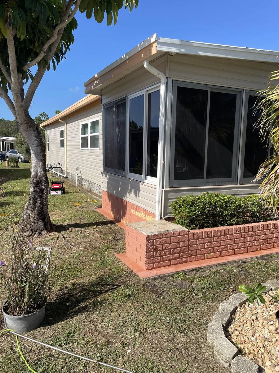 Exterior project 3, before &mdash; corner with unpainted brick skirting