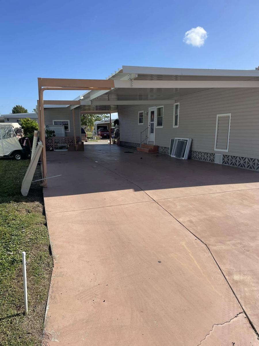 Exterior project 3, before &mdash; carport and worn driveway slab